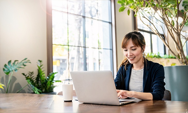 A woman working on her laptop.